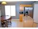 Kitchen featuring wooden cabinetry, stainless-steel appliances, and granite countertops with an adjacent eat-in dining area at 7340 Alpine Ridge St, Las Vegas, NV 89131