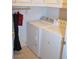 Functional laundry room featuring a side-by-side washer and dryer setup, maximizing space and convenience at 7340 Alpine Ridge St, Las Vegas, NV 89131