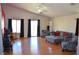 Spacious living room featuring high ceilings, wood-look flooring, and lots of natural light at 7340 Alpine Ridge St, Las Vegas, NV 89131