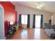 Spacious living room with a red accent wall, hardwood flooring, and natural light at 7340 Alpine Ridge St, Las Vegas, NV 89131