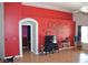 Living room showcasing an artistic red wall, hardwood flooring, and neutral accents at 7340 Alpine Ridge St, Las Vegas, NV 89131