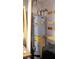 Efficient water heater unit, showcasing energy guide sticker with organized shelving and storage nearby at 7340 Alpine Ridge St, Las Vegas, NV 89131