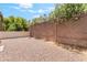 Private backyard featuring rock landscaping, a tall brick wall, and lush greenery for added seclusion at 7553 Virginia Dale St, Las Vegas, NV 89131
