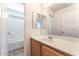 Bathroom featuring a vanity with a sink, mirror, and a separate room with a tub and shower, providing functionality at 7553 Virginia Dale St, Las Vegas, NV 89131