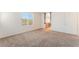 Bedroom featuring carpet floors, bright natural light, and open doorway to bathroom at 7553 Virginia Dale St, Las Vegas, NV 89131