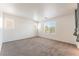 Sunlit bedroom with neutral carpet and multiple windows providing natural light at 7553 Virginia Dale St, Las Vegas, NV 89131