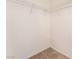 Walk-in closet with carpeted floors and white wire shelving, offering ample storage space for clothing and accessories at 7553 Virginia Dale St, Las Vegas, NV 89131