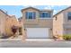 Two-story home with neutral stucco, matching shutters, a front yard, and a two car garage at 7553 Virginia Dale St, Las Vegas, NV 89131