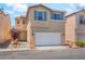 Two-story home with neutral stucco, matching shutters, a front yard, and a two car garage at 7553 Virginia Dale St, Las Vegas, NV 89131