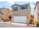 A charming two-story home with neutral stucco, matching shutters, a front yard, and a two car garage at 7553 Virginia Dale St, Las Vegas, NV 89131