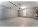 Clean garage with painted floors and walls, with visible water heater at 7553 Virginia Dale St, Las Vegas, NV 89131