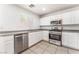 Bright kitchen featuring stainless steel appliances, tile flooring and white cabinetry at 7553 Virginia Dale St, Las Vegas, NV 89131