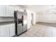 Bright kitchen showcasing stainless steel refrigerator and seamless flow into living area at 7553 Virginia Dale St, Las Vegas, NV 89131