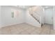 Entry of the home featuring a staircase, carpet, tile flooring, and a sidelight for more natural light at 7553 Virginia Dale St, Las Vegas, NV 89131