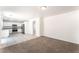 Open living room featuring carpet, tile flooring, and a kitchen with stainless steel appliances at 7553 Virginia Dale St, Las Vegas, NV 89131