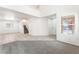 Large living room with a staircase, carpet, tile flooring, and large windows for plenty of natural light at 7553 Virginia Dale St, Las Vegas, NV 89131