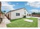 Manicured backyard featuring artificial turf, patio space, and privacy fencing at 7927 Villa Salsa Ave, Las Vegas, NV 89131