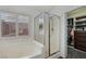 Bathroom showcasing a soaking tub, shower, window, and walk-in closet at 7927 Villa Salsa Ave, Las Vegas, NV 89131