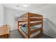 Cozy bedroom featuring carpet and a wooden bunk bed with colorful bedding at 7927 Villa Salsa Ave, Las Vegas, NV 89131