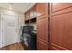 Laundry room with black washer and dryer and ample storage cabinets at 7927 Villa Salsa Ave, Las Vegas, NV 89131