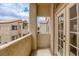 Cozy balcony with stucco walls, double doors, and community views at 8301 Boseck Dr # 232, Las Vegas, NV 89145