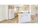 Well-lit kitchen with wooden cabinets, white appliances, and tiled countertops at 8301 Boseck Dr # 232, Las Vegas, NV 89145