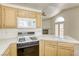 Kitchen view showcasing oak cabinets, gas range, and tiled countertops at 8301 Boseck Dr # 232, Las Vegas, NV 89145