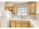 Bright kitchen featuring oak cabinets, white tile countertops, and a modern faucet at 8301 Boseck Dr # 232, Las Vegas, NV 89145