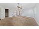 Large bedroom with neutral paint, carpeting, ceiling fan, and multiple access doors at 9409 Kayla Ct, Las Vegas, NV 89134