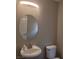 Powder room with an oval mirror and a modern sink and toilet at 9556 Ancala Hollow Ct, Las Vegas, NV 89148