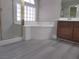 Bathroom with a separate shower, tub, and vanity with dark wood cabinets at 9556 Ancala Hollow Ct, Las Vegas, NV 89148
