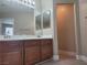 Bathroom featuring a double sink vanity with wood cabinets and an attached toilet at 9556 Ancala Hollow Ct, Las Vegas, NV 89148
