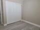 This bedroom features plank flooring and a closet with sliding doors at 9556 Ancala Hollow Ct, Las Vegas, NV 89148