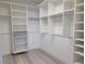 Walk-in closet with custom white shelving and drawers to keep your wardrobe organized at 9556 Ancala Hollow Ct, Las Vegas, NV 89148