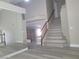 Open home entrance area features a staircase, mirror and neutral interior paint scheme at 9556 Ancala Hollow Ct, Las Vegas, NV 89148