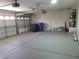 Spacious garage with epoxy flooring, storage, and an automatic garage door at 9556 Ancala Hollow Ct, Las Vegas, NV 89148