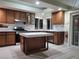 Kitchen boasts stainless steel appliances, light countertops, and wooden cabinets at 9556 Ancala Hollow Ct, Las Vegas, NV 89148