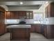 Modern kitchen with stainless steel appliances, island, updated cabinets, and light countertops at 9556 Ancala Hollow Ct, Las Vegas, NV 89148