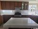 Gourmet kitchen with marble countertops, stainless appliances, and ample cabinet storage at 9556 Ancala Hollow Ct, Las Vegas, NV 89148