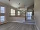 Bright living room featuring light wood floors, staircase, and ample natural light from large windows at 9556 Ancala Hollow Ct, Las Vegas, NV 89148