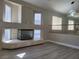 Bright living area features wood floors, fireplace with marble accents, and modern lighting at 9556 Ancala Hollow Ct, Las Vegas, NV 89148