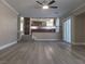 Open-concept living room offers a view into the kitchen with hardwood cabinetry at 9556 Ancala Hollow Ct, Las Vegas, NV 89148