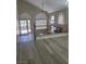 Sun-filled living room with wood-look floors and large windows at 9556 Ancala Hollow Ct, Las Vegas, NV 89148