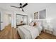Inviting bedroom featuring wood floors, mirrored closet doors, and modern leaf art at 9900 Summer Ash Ct # 103, Las Vegas, NV 89134