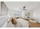 Well-lit bedroom featuring wood floors, ceiling fan, window views, and neutral decor at 9900 Summer Ash Ct # 103, Las Vegas, NV 89134