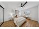 Stylish bedroom showcasing a ceiling fan, wood floors, palm tree art, and bright natural light at 9900 Summer Ash Ct # 103, Las Vegas, NV 89134