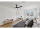 Bedroom with wood floors, ceiling fan, bright window views, and contemporary furniture at 9900 Summer Ash Ct # 103, Las Vegas, NV 89134