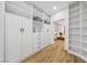 Large walk-in closet with custom built-in shelving and drawers provides ample storage at 9900 Summer Ash Ct # 103, Las Vegas, NV 89134