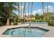 Community spa featuring well-maintained landscaping, lounge chairs, and palm trees at 9900 Summer Ash Ct # 103, Las Vegas, NV 89134