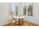 Cozy breakfast nook with bright light coming through windows and stylish tulip chairs at 9900 Summer Ash Ct # 103, Las Vegas, NV 89134